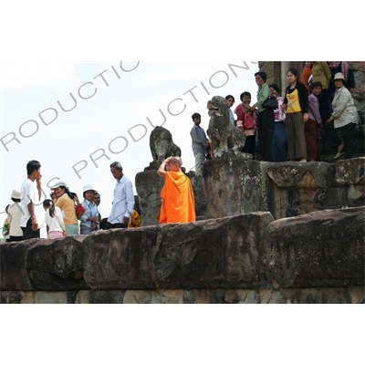 Buddhist Monks and Tourists on Terrace of Bakong in Angkor