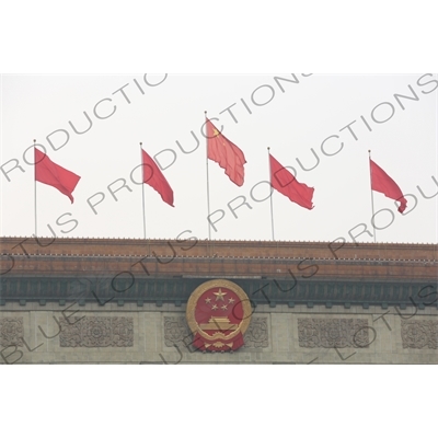 Communist Party of China Insignia and Red Flags on the Great Hall of the People (Renmin Dahuitang) on the West side of Tiananmen Square in Beijing