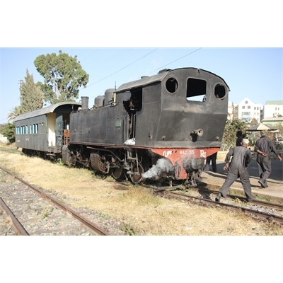 Driver and Engineer Inspecting a Vintage Steam Engine Going from Asmara to Massawa