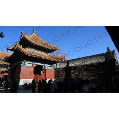 People Throwing Coins at an Incense Burner for Luck in front of the Four Language Stele Pavilion/Imperial Handwriting Pavilion in the Lama Temple in Beijing