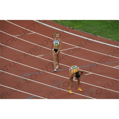 Athletes at the end of a Women's 3,000 Metre Steeplechase Heat in the Bird's Nest/National Stadium (Niaochao/Guojia Tiyuchang) in the Olympic Park in Beijing