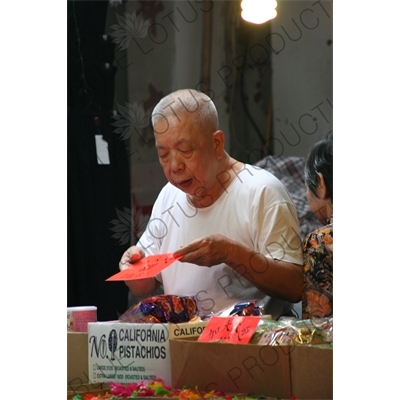 Man Setting up a Stall at a Street Market in Hong Kong