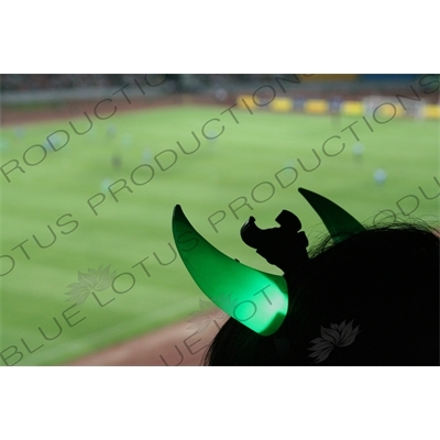 Beijing Guoan Fan's Flashing Green Horns during a Chinese Super League Match against Dalian Shide at the Workers' Stadium (Gongren Tiyuchang) in Beijing