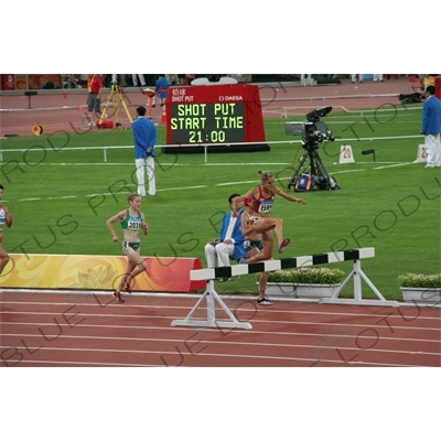 Athlete Jumping Barrier in a Women's 3,000 Metre Steeplechase Heat in the Bird's Nest/National Stadium (Niaochao/Guojia Tiyuchang) in the Olympic Park in Beijing