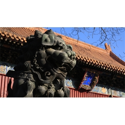 Guardian Lion Statue and Gate of Peace and Harmony (Yonghe Men) in the Lama Temple in Beijing