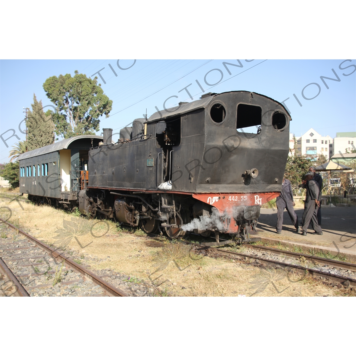 Driver and Engineer Inspecting a Vintage Steam Engine Going from Asmara to Massawa