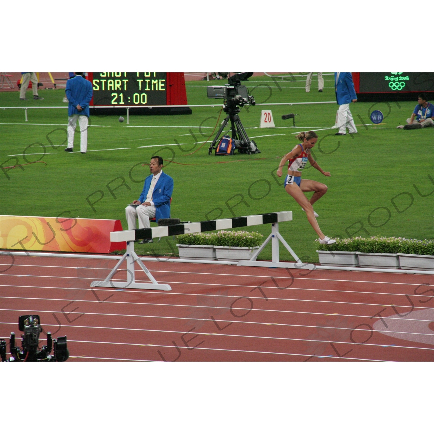 Athlete Jumping Barrier in a Women's 3,000 Metre Steeplechase Heat in the Bird's Nest/National Stadium (Niaochao/Guojia Tiyuchang) in the Olympic Park in Beijing