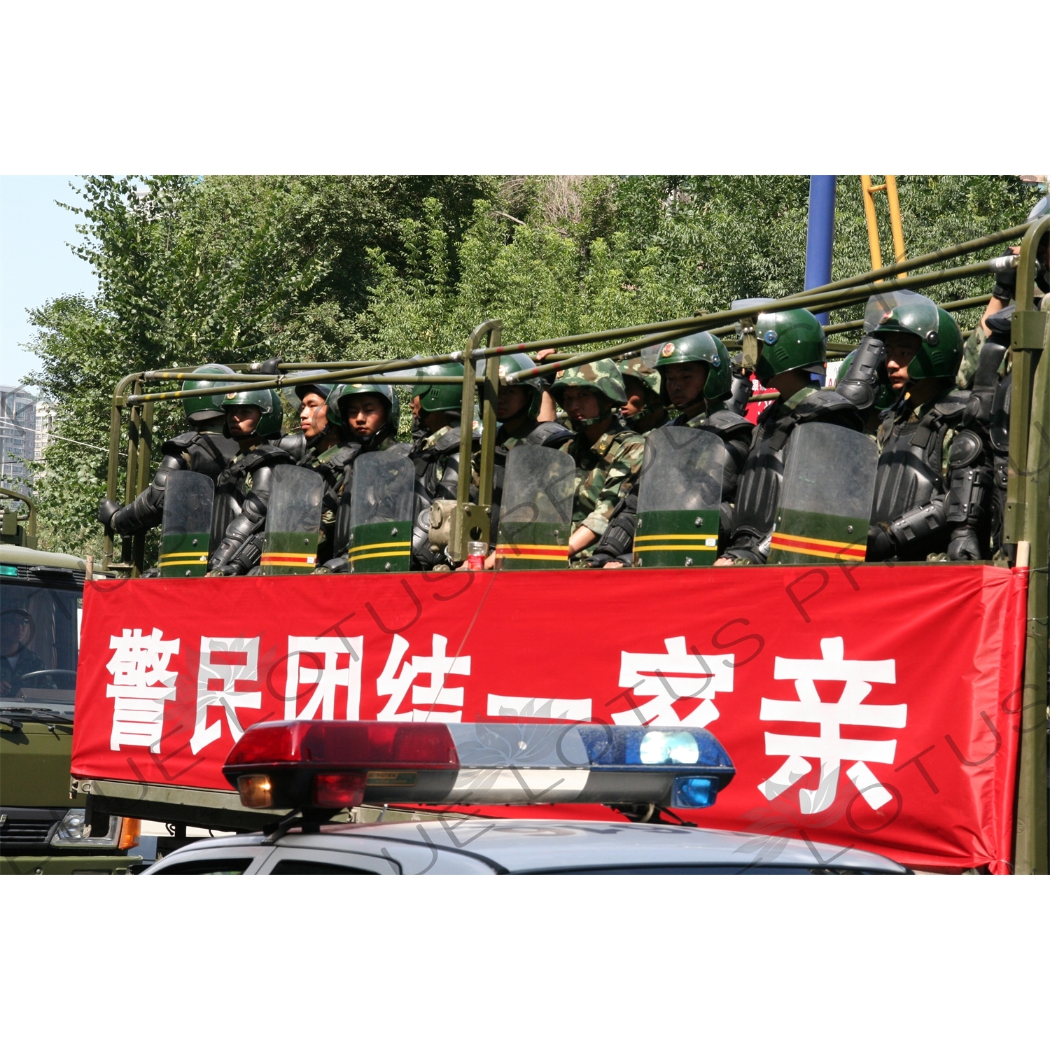 Chinese People's Armed Police Force/PAP (Zhongguo Renmin Wuzhuang Jingcha Budui/Wujing) Officers in a Personnel Transport Vehicle in Urumqi