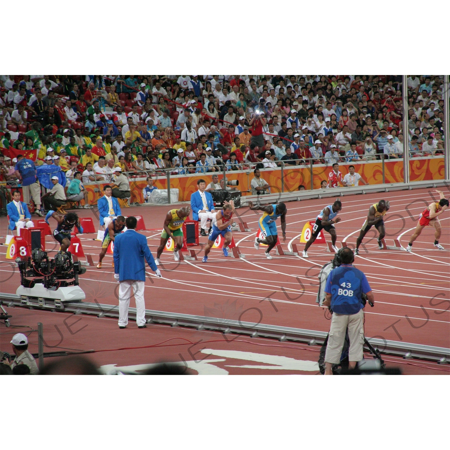 Athletes at the Start of a Men's 100 Metres Heat in the Bird's Nest/National Stadium (Niaochao/Guojia Tiyuchang) in the Olympic Park in Beijing