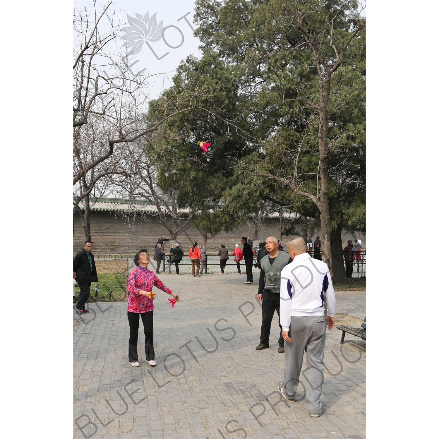 People Playing Shuttlecock (Jianzi/Ti Jianzi/Jianqiu) near the North Gate of the Temple of Heaven (Tiantan) in Beijing