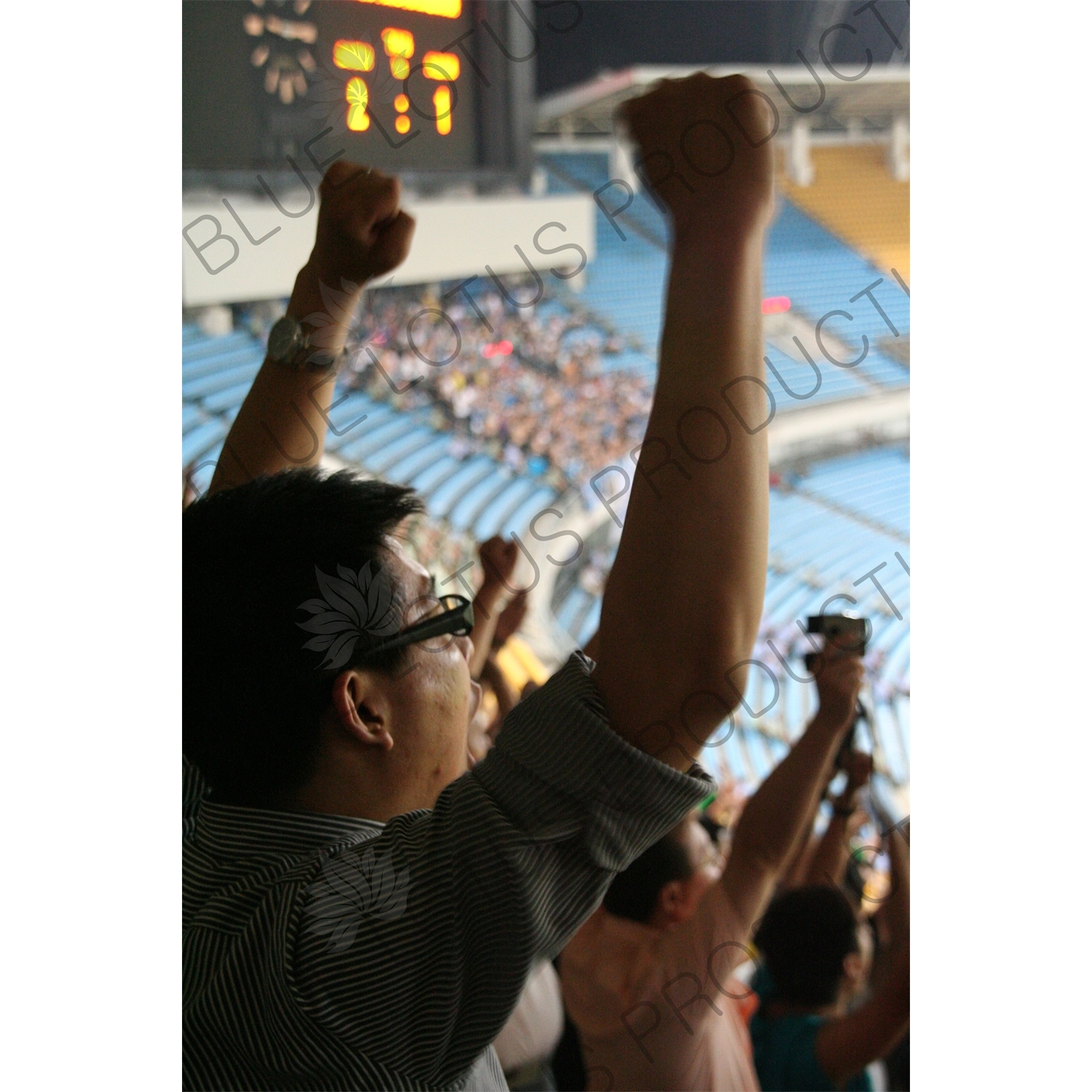 Beijing Guoan Fans Celebrating a Goal during a Chinese Super League Match against Dalian Shide at the Workers' Stadium (Gongren Tiyuchang) in Beijing