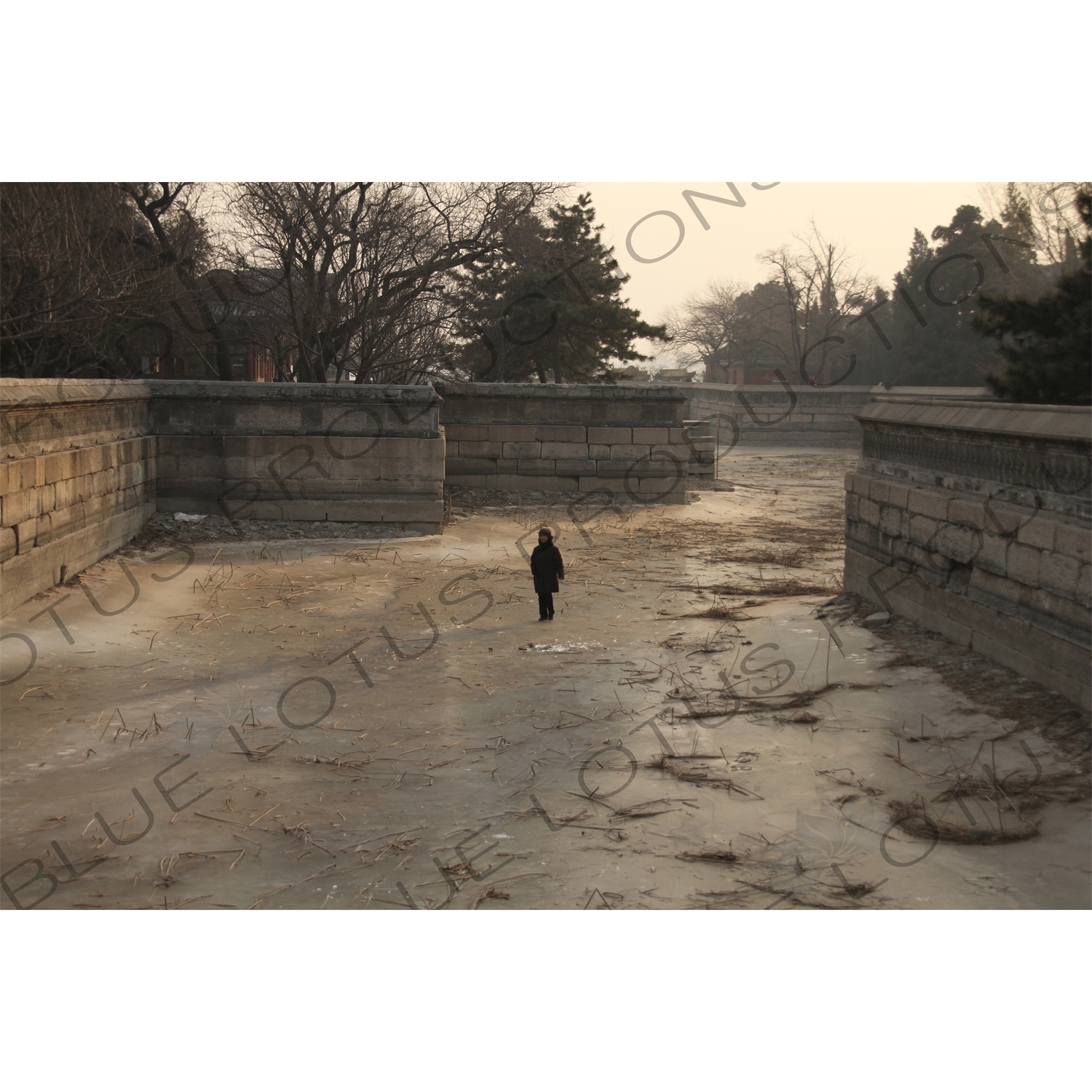 Woman Walking on a Frozen Kunming Lake in the Summer Palace in Beijing