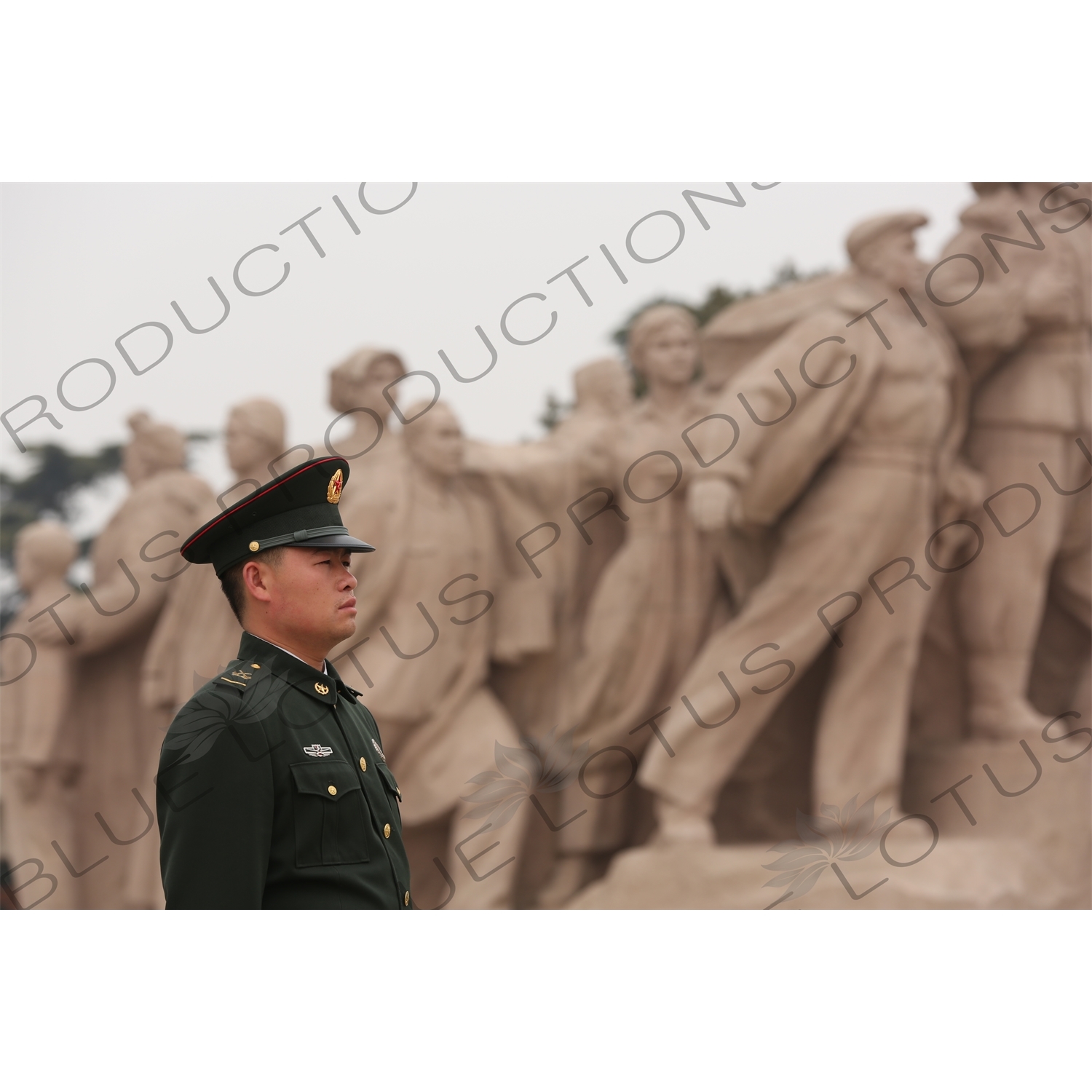 Soldier in front of a 'Heroes of the Revolution' Sculpture outside the Chairman Mao Memorial Hall/Mao's Mausoleum (Mao Zhuxi Jinnian Tang) in Tiananmen Square in Beijing