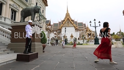 People Taking Pictures next to a Royal Guards Soldier at the entrance of Phra Thinang Chakri Maha Prasat at the Grand Palace (Phra Borom Maha Ratcha Wang) in Bangkok