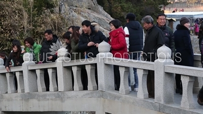 People Throwing Coins in the 'Lucky Coin Divination' Area of Haedong Yonggung Temple (Haedong Yonggungsa) in Busan