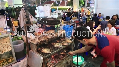 Man Cooking Fish at a Street Restaurant at Ratchaprasong Protest Camp in Bangkok