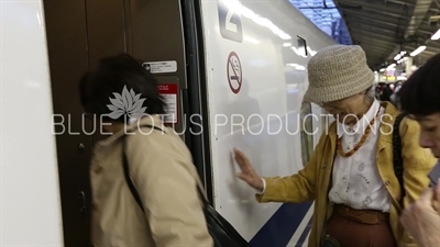 Passengers Boarding a Bullet Train (Shinkansen) at Tokyo Station