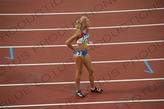 Athlete at the End of a Women's 100 Metres Heat in the Bird's Nest/National Stadium (Niaochao/Guojia Tiyuchang) in the Olympic Park in Beijing