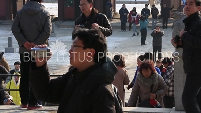 Tourists Taking Photos in front of Geunjeong Hall (Geunjeongjeon) at Gyeongbok Palace (Gyeongbokgung) in Seoul