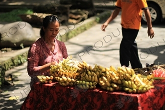 Woman Selling Bananas at a Stall on the side of the Road in Bali