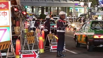 Construction Workers Directing Traffic in Shibuya in Tokyo