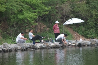 People Fishing in the Reservoir of the Huanghua Cheng Section of the Great Wall of China (Wanli Changcheng) near Beijing