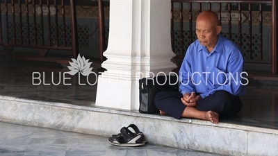Man Meditating at the Emerald Temple/Chapel (Wat Phra Kaew) at the Grand Palace (Phra Borom Maha Ratcha Wang) in Bangkok