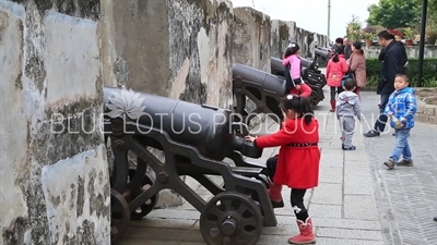 Children Playing on a Cannon in Monte Fort (Fortaleza do Monte) in Macau