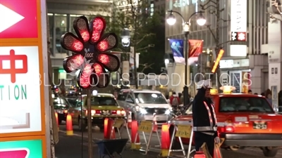 Construction Worker Directing Traffic in Shibuya in Tokyo