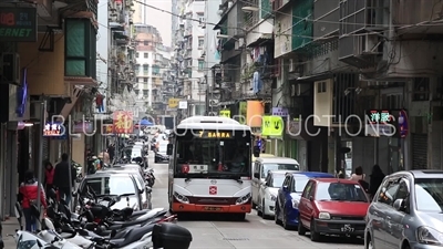 Bus Driving Down a Street in Macau