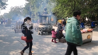 People Burning Incense and Praying at Po Lin Monastery on Lantau Island
