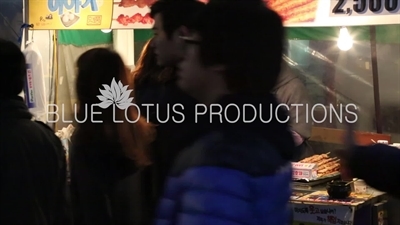 Woman Buying Food at a Street Stall in Seoul