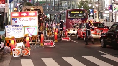 Construction Workers Directing Traffic in Shibuya in Tokyo