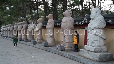 Children Having Their Picture Taken in front of the Twelve Zodiac Animals Statues at Haedong Yonggung Temple (Haedong Yonggungsa) in Busan