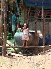 Cambodian Girl Holding up Three Fingers by the Side of a Road in Angkor