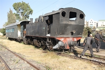 Driver and Engineer Inspecting a Vintage Steam Engine Going from Asmara to Massawa