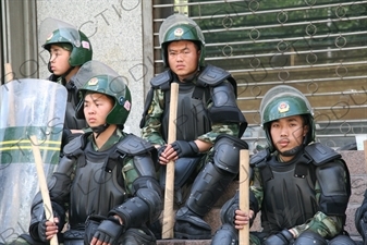 Chinese People's Armed Police Force/PAP (Zhongguo Renmin Wuzhuang Jingcha Budui/Wujing) Officers in Riot Gear on a Street in Urumqi