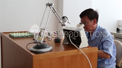 Worker Testing a Watch Mechanism at 'Sea Gull Watch Group' Factory in Tianjin