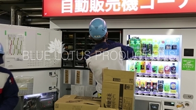 Workers Refilling a Vending Machine in Tokyo station