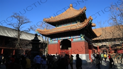 People Throwing Coins at an Incense Burner for Luck in front of the Four Language Stele Pavilion/Imperial Handwriting Pavilion in the Lama Temple in Beijing