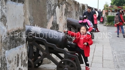 Children Playing on a Cannon in Monte Fort (Fortaleza do Monte) in Macau