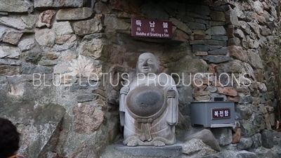 The 'Buddha of Granting a Son' Statue at the Entrance to Haedong Yonggung Temple (Haedong Yonggungsa) in Busan