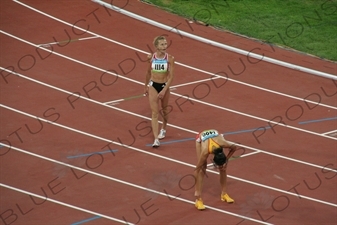 Athletes at the end of a Women's 3,000 Metre Steeplechase Heat in the Bird's Nest/National Stadium (Niaochao/Guojia Tiyuchang) in the Olympic Park in Beijing