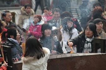 People Burning Incense in the Lama Temple (Yonghegong) in Beijing