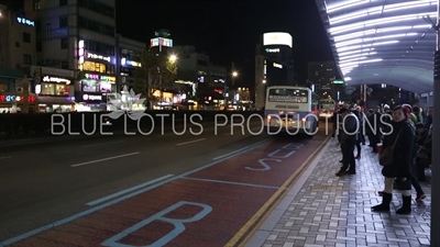 Passengers Waiting at a Bus Stop in Busan