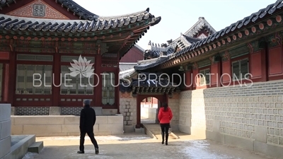 People walking behind Gangnyeong Hall (Gangnyeongjeon) at Gyeongbok Palace (Gyeongbokgung) in Seoul