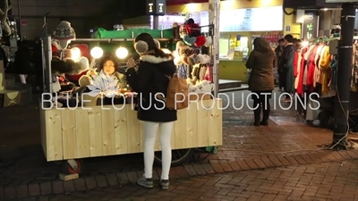 Woman Shopping at a Street Stall in Seoul