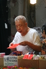 Man Setting up a Stall at a Street Market in Hong Kong