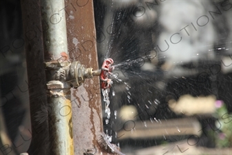 Water Being Expelled from a Pipe on a Vintage Steam Engine Going from Asmara to Massawa