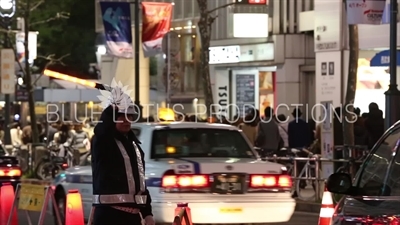 Construction Worker Directing Traffic in Shibuya in Tokyo